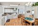 Bright kitchen featuring white cabinets, modern appliances, and an adjacent dining area with a wooden table set at 34506 Rose N Dr, Pinellas Park, FL 33781