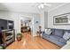 Cozy living room setup with comfortable sofas, hardwood floors, and an open layout to other living spaces at 34506 Rose N Dr, Pinellas Park, FL 33781