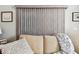 Cozy living room featuring comfortable seating, a throw blanket, and vertical blinds at 34506 Rose N Dr, Pinellas Park, FL 33781