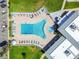 Aerial shot of a stylish outdoor pool and patio with abundant seating for community enjoyment at 34506 Rose N Dr, Pinellas Park, FL 33781
