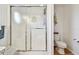 Close-up of glass-enclosed shower with frosted doors and toilet in a bright bathroom at 34506 Rose N Dr, Pinellas Park, FL 33781