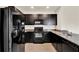 The kitchen is equipped with granite countertops, tile backsplash, and matching appliances at 3503 Diamond Leaf Ct, Valrico, FL 33594