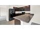Open kitchen featuring granite countertops, a black refrigerator, and a stainless steel double sink at 3503 Diamond Leaf Ct, Valrico, FL 33594