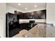 Spacious kitchen features sleek, black appliances, granite countertops, and ample storage at 3503 Diamond Leaf Ct, Valrico, FL 33594
