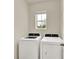 The laundry room includes a new, white washer and dryer set plus a window at 3503 Diamond Leaf Ct, Valrico, FL 33594