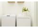 Bright laundry room featuring a stacked washer and dryer for efficient space-saving convenience at 3652 Forest Path Dr, Plant City, FL 33565