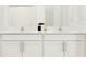 Bright bathroom featuring dual sinks, white cabinets, and modern fixtures at 3711 Forest Path Dr, Plant City, FL 33565