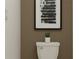 Bathroom with a contemporary toilet, neutral walls, and framed modern art at 3711 Forest Path Dr, Plant City, FL 33565