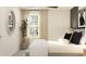 Bright bedroom with a neutral color palette, modern decor, and a large window at 3711 Forest Path Dr, Plant City, FL 33565