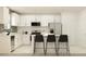 Modern kitchen with white cabinetry, stainless steel appliances, and a stylish center island with seating at 3711 Forest Path Dr, Plant City, FL 33565