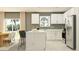 Open-concept kitchen with white cabinetry, stainless steel appliances, and a center island with bar stools at 3711 Forest Path Dr, Plant City, FL 33565