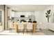 Open-concept kitchen with white cabinetry, modern appliances, and a dining area at 3711 Forest Path Dr, Plant City, FL 33565