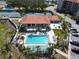 Aerial view of pool and tennis courts; enjoy resort style living in this community at 433 Mariner Dr # 433, Tarpon Springs, FL 34689