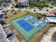 Aerial view of tennis and pickle ball courts with ample parking and pristine landscaping at 433 Mariner Dr # 433, Tarpon Springs, FL 34689