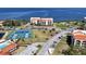 Overhead view of community with tennis courts, pool, and manicured landscaping at 433 Mariner Dr # 433, Tarpon Springs, FL 34689