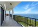 Large balcony with black metal railing overlooking the ocean at 433 Mariner Dr # 433, Tarpon Springs, FL 34689