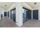 A long balcony featuring multiple glass sliders and tile floors at 433 Mariner Dr # 433, Tarpon Springs, FL 34689