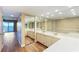 Spacious bathroom with double sinks, mirrored wall and wood look floors at 433 Mariner Dr # 433, Tarpon Springs, FL 34689