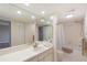 Bright bathroom with a large mirror, white vanity, and shower-tub combination with neutral tile at 433 Mariner Dr # 433, Tarpon Springs, FL 34689