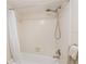 Close up of neutral tile surround of bathtub shower combination, neutral tile and silver fixtures at 433 Mariner Dr # 433, Tarpon Springs, FL 34689