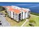 Stunning waterfront condo featuring a red tile roof and lush landscaping at 433 Mariner Dr # 433, Tarpon Springs, FL 34689