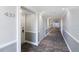 Hallway with neutral colored walls and carpeting with doors leading to units at 433 Mariner Dr # 433, Tarpon Springs, FL 34689