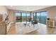 Open living room with water views from the balcony, comfortable seating, and decorative artwork at 433 Mariner Dr # 433, Tarpon Springs, FL 34689
