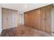 Bedroom featuring wood floors and built-in closet systems on two walls at 433 Mariner Dr # 433, Tarpon Springs, FL 34689