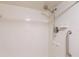 The white tiled shower features a handheld shower head and a grab bar at 433 Mariner Dr # 433, Tarpon Springs, FL 34689