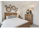 Comfortable bedroom with a stylish headboard, decorative wall hangings, and warm lighting at 4587 Georgia Ave, North Port, FL 34288