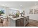 Open concept kitchen with quartz island and view to dining room and living room at 4587 Georgia Ave, North Port, FL 34288