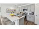 Stylish kitchen featuring gray cabinets, stainless appliances, quartz counters and bar stool seating at 4587 Georgia Ave, North Port, FL 34288