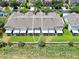 Aerial view of the rear of the townhome complex with screened in patios and green lawns at 4862 Pond Ridge Dr, Riverview, FL 33578
