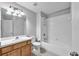 A clean bathroom featuring a shower-tub combo with white tiles, vanity and lighting at 4862 Pond Ridge Dr, Riverview, FL 33578