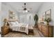 Charming bedroom with decorative rug, lamps, and a large potted cactus to bring the outside indoors at 4862 Pond Ridge Dr, Riverview, FL 33578