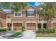 Inviting two-story townhome featuring a two-car garage and manicured landscaping at 4862 Pond Ridge Dr, Riverview, FL 33578