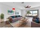 Bright living room featuring a modern ceiling fan, comfortable seating, and access to a screened lanai at 4862 Pond Ridge Dr, Riverview, FL 33578