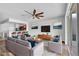 Open-concept living room with a modern ceiling fan, stylish furniture, and a view of the adjacent kitchen at 4862 Pond Ridge Dr, Riverview, FL 33578