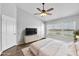 Serene main bedroom with a ceiling fan, large window with a water view, and a spacious layout at 4862 Pond Ridge Dr, Riverview, FL 33578