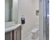 Elegant bathroom with a glass-door shower, toilet, and a sleek vanity with a large mirror at 4910 W Mcelroy Ave # 6, Tampa, FL 33611