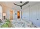 Bright bedroom showing en-suite bathroom, ceiling fan, and ample closet space at 4910 W Mcelroy Ave # 6, Tampa, FL 33611