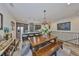 Open dining area featuring a large wood table and a stylish chandelier near the modern kitchen at 4910 W Mcelroy Ave # 6, Tampa, FL 33611