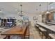 Dining room and kitchen area with hard wood floors, natural lighting, island seating, and stainless appliances at 4910 W Mcelroy Ave # 6, Tampa, FL 33611