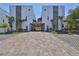 Stunning exterior view of modern townhomes with brick driveways and beautiful landscaping at 4910 W Mcelroy Ave # 6, Tampa, FL 33611