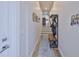 Inviting hallway with wooden floors, storage rack, leading to staircase and other living spaces at 4910 W Mcelroy Ave # 6, Tampa, FL 33611