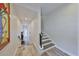 Bright hallway showcasing staircase with open floor plan leading to a welcoming white door at 4910 W Mcelroy Ave # 6, Tampa, FL 33611