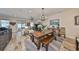 Open living room and dining area featuring hardwood floors and an abundance of natural light at 4910 W Mcelroy Ave # 6, Tampa, FL 33611