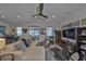 Spacious living room with hardwood floors, recessed lighting, piano, and an abundance of natural light at 4910 W Mcelroy Ave # 6, Tampa, FL 33611