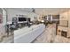 Spacious living room flowing into a modern kitchen and dining area with hardwood floors at 4910 W Mcelroy Ave # 6, Tampa, FL 33611