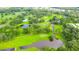 Aerial shot of a beautiful golf course with lush fairways, serene ponds and manicured greens at 5646 Cheyenne St, Zephyrhills, FL 33542